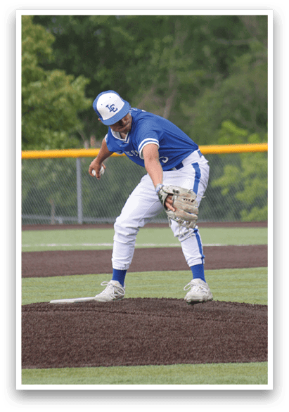 A baseball player in a blue and white uniform is in the process of throwing a ball. Description generated by AI