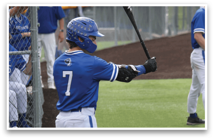 A baseball player holding a bat. Description generated by AI
