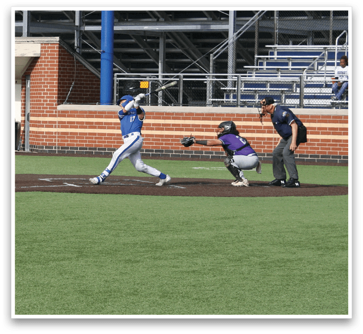 A baseball player in a blue shirt and white pants is running towards a base. Description generated by AI