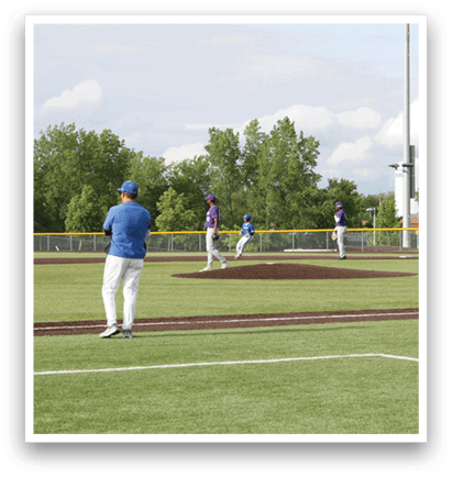 A baseball game is being played on a field. Description generated by AI