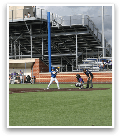 A baseball player is swinging a bat on a field. Description generated by AI
