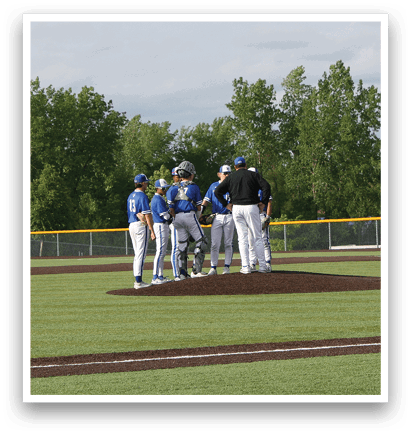 A group of baseball players standing on a field. Description generated by AI