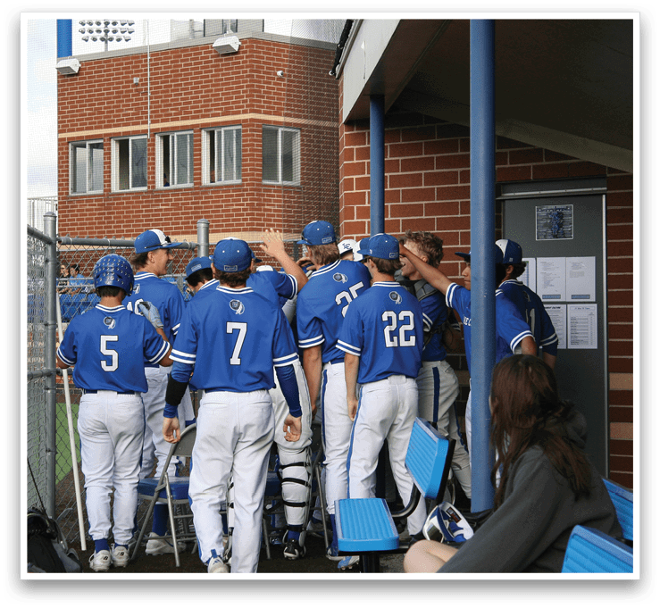 Baseball players in blue and white uniforms. Description generated by AI