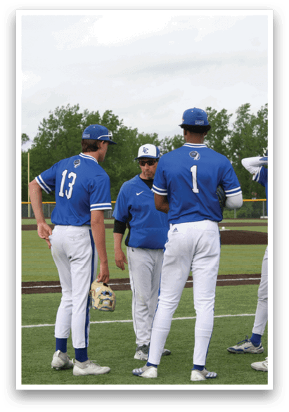 A group of baseball players wearing blue and white uniforms. Description generated by AI
