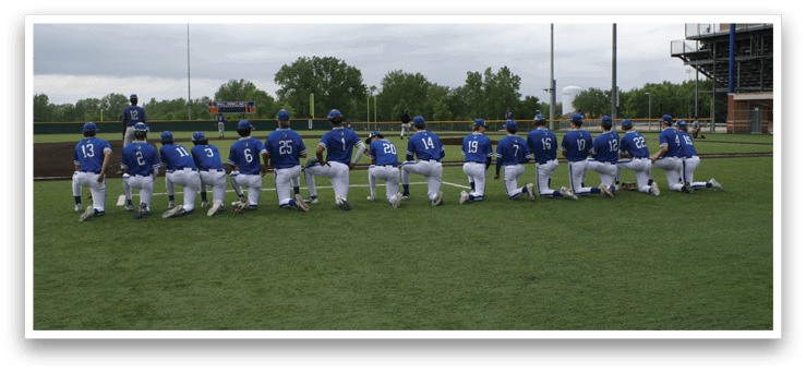 Baseball players in blue and white uniforms. Description generated by AI