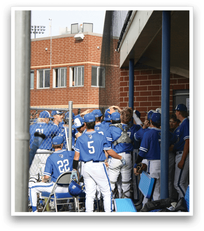 A group of baseball players wearing blue and white uniforms. Description generated by AI