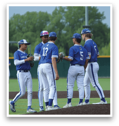 A group of baseball players wearing blue and white uniforms. Description generated by AI