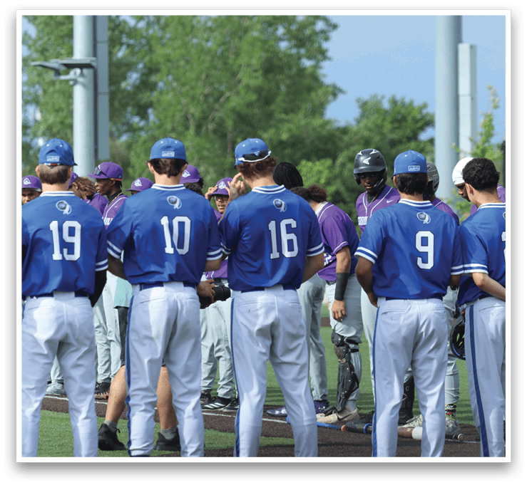 A group of baseball players wearing blue shirts and white pants. Description generated by AI
