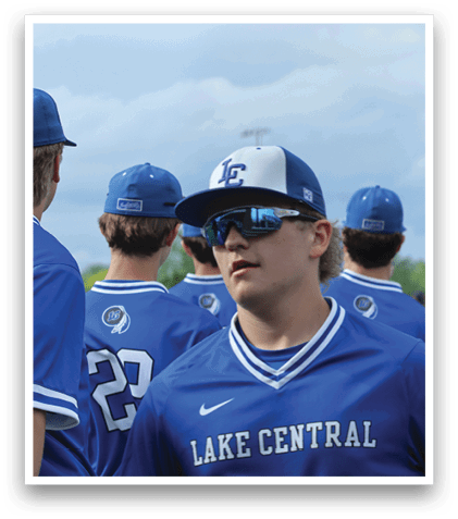 A group of baseball players wearing blue uniforms. Description generated by AI