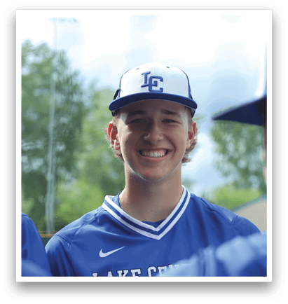 A man wearing a blue and white baseball uniform with the letter L on it. Description generated by AI