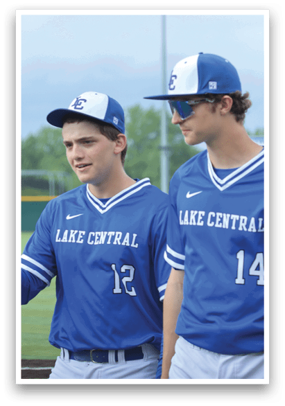 Three baseball players wearing blue uniforms. Description generated by AI