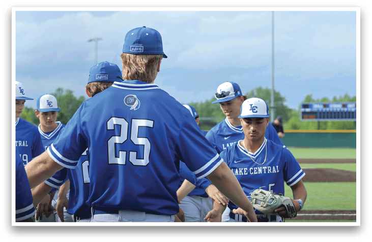 A group of baseball players wearing blue shirts and blue hats. Description generated by AI