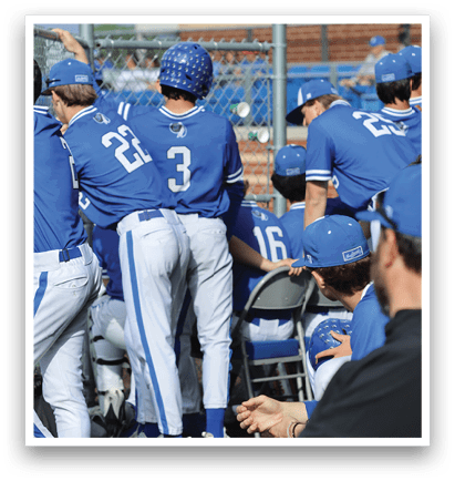 A group of baseball players wearing blue uniforms. Description generated by AI