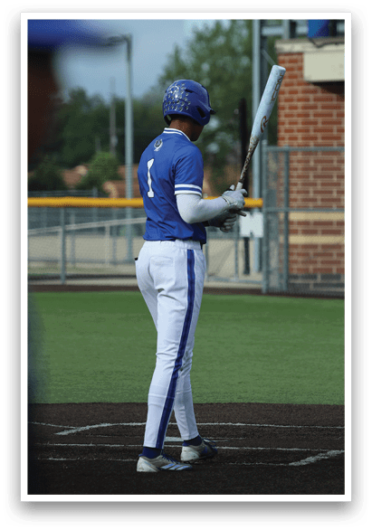 A baseball player holding a bat. Description generated by AI