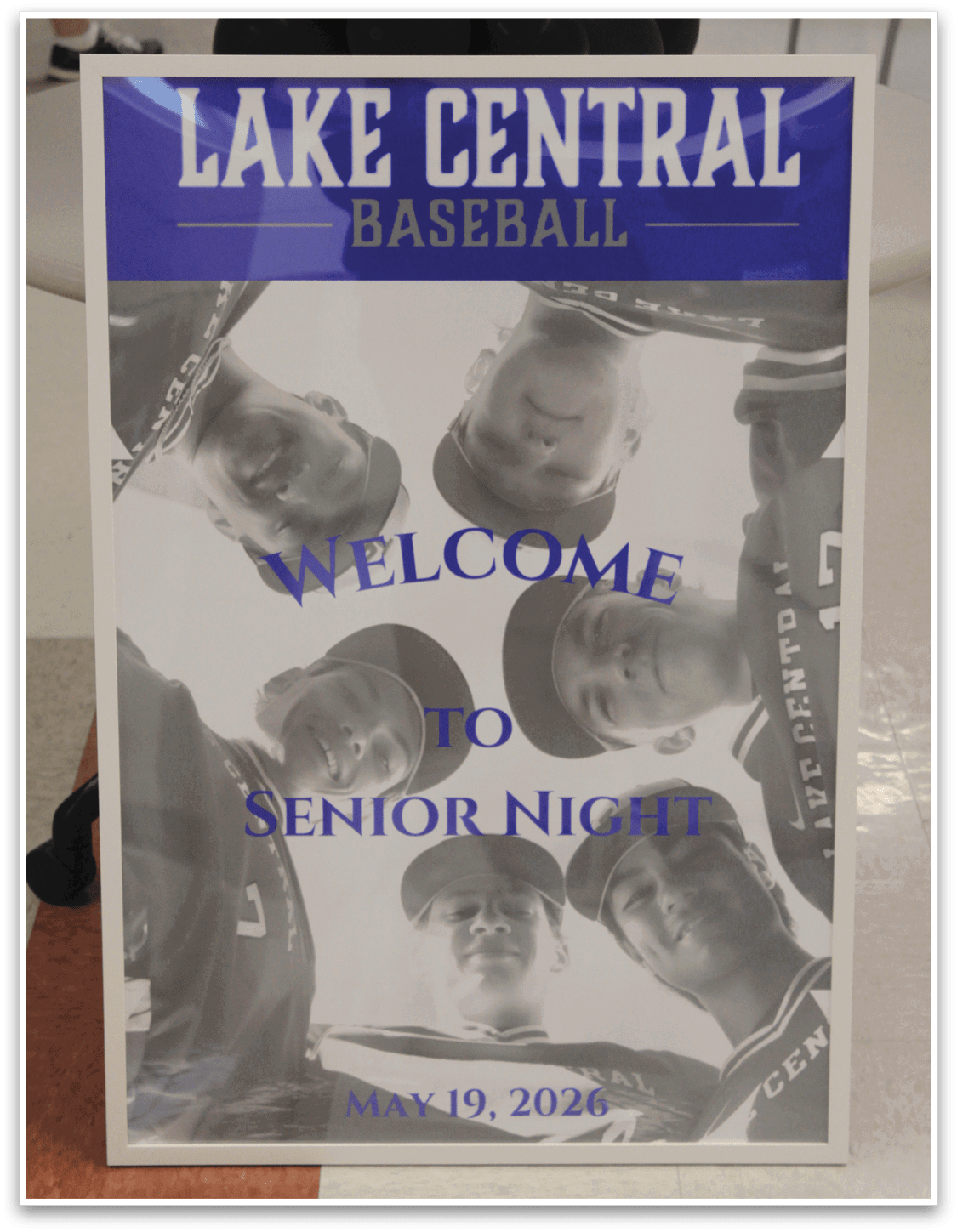 A blue and white sign with a picture of a group of men on it. Description generated by AI