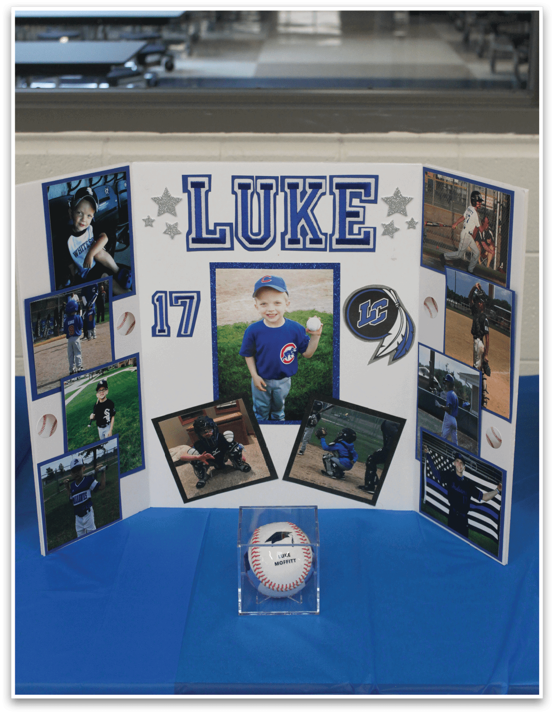A display of photos and a baseball. Description generated by AI