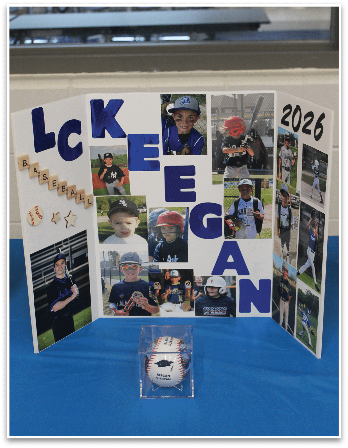 A display of photos and a baseball. Description generated by AI