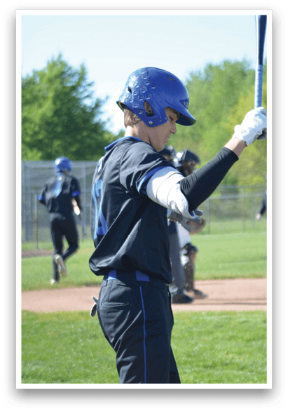 A baseball player in a blue helmet and black shirt holding a bat. Description generated by AI