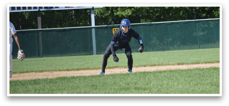A baseball player in a blue helmet and black uniform is running to first base. Description generated by AI