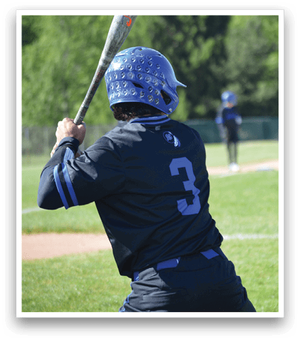 A baseball player in a black shirt and blue helmet is swinging a bat. Description generated by AI
