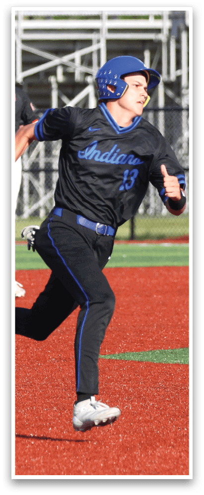 A baseball player in a black shirt and blue hat is throwing a baseball. Description generated by AI