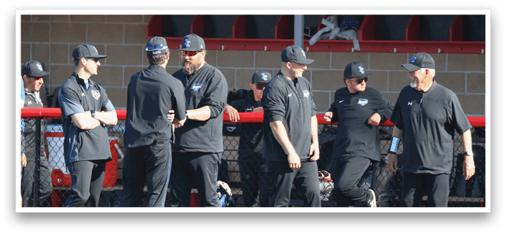 A group of men wearing black shirts and hats. Description generated by AI