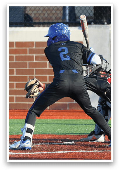 A baseball player is at bat, wearing a blue helmet and black uniform. Description generated by AI