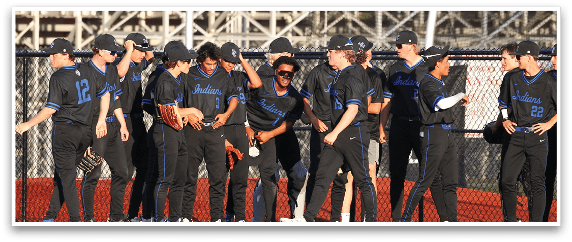 Baseball players standing on a field. Description generated by AI