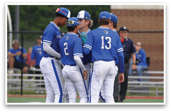 A group of baseball players wearing blue and white uniforms. Description generated by AI