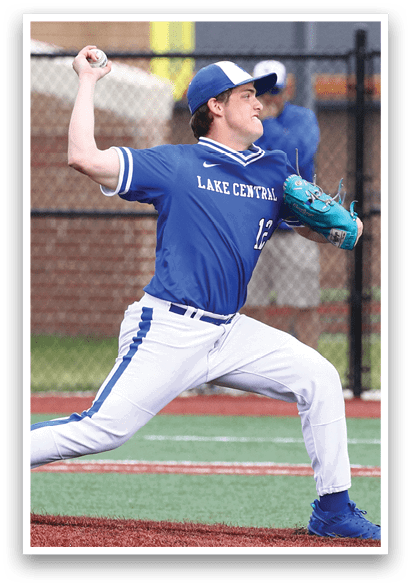 A baseball player in a blue and white uniform is pitching a ball. Description generated by AI