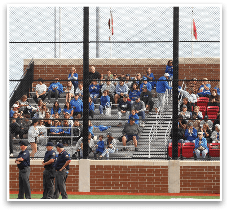 A group of people are sitting in the stands at a baseball game. Description generated by AI