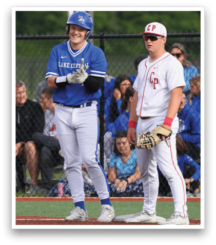 A baseball player wearing a blue and white uniform stands on the field. Description generated by AI