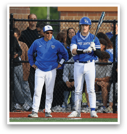 A baseball player holding a bat. Description generated by AI