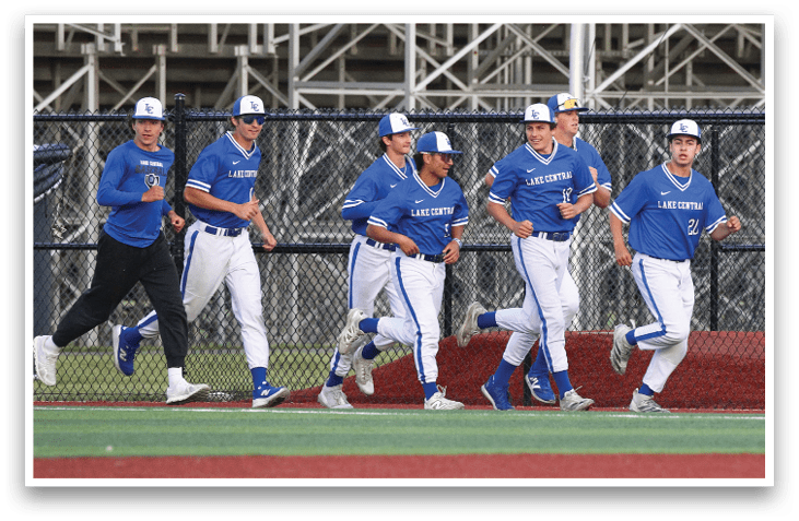 A group of baseball players wearing blue uniforms. Description generated by AI