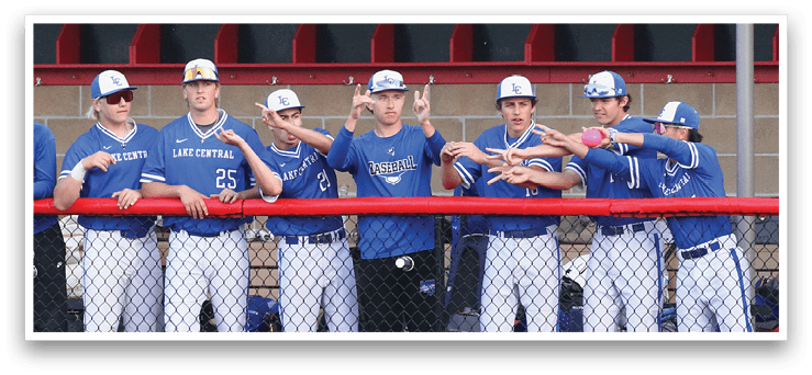 A group of baseball players wearing blue uniforms. Description generated by AI