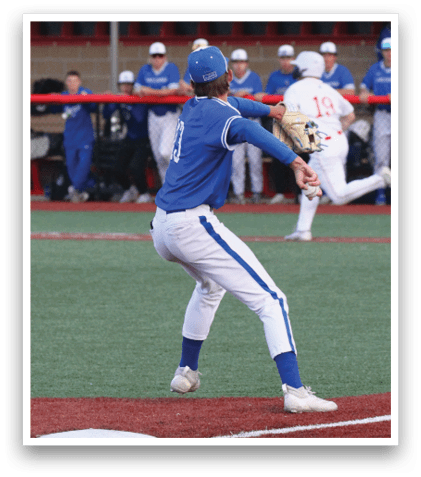 A baseball player in a blue and white uniform is throwing a ball. Description generated by AI