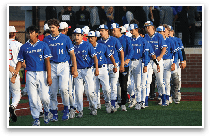 A group of baseball players wearing blue uniforms. Description generated by AI