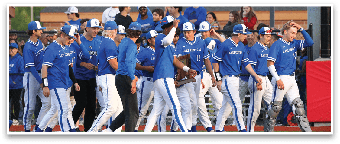 A group of baseball players wearing blue shirts and white pants. Description generated by AI