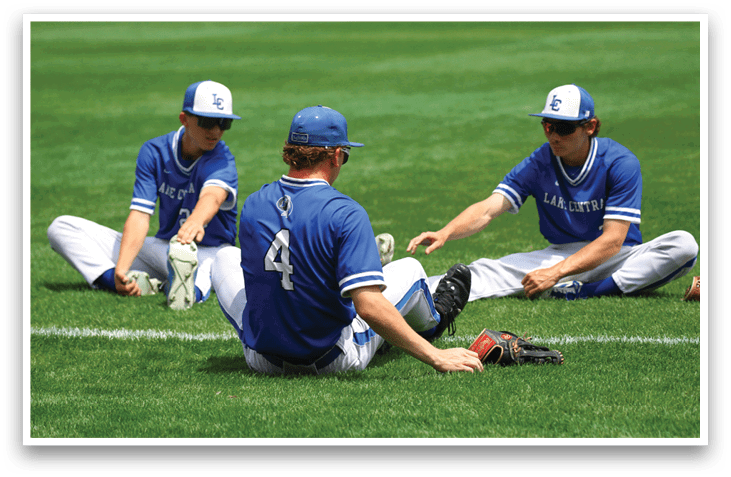 Three baseball players sitting on the grass. Description generated by AI