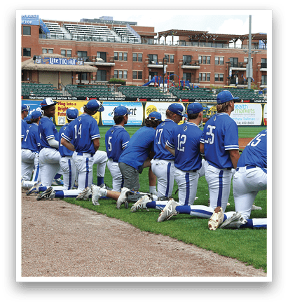 Baseball players wearing blue uniforms. Description generated by AI