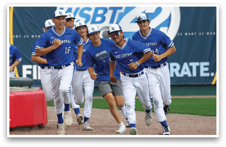 A group of baseball players running on a field. Description generated by AI