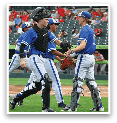 A group of baseball players wearing blue and white uniforms. Description generated by AI