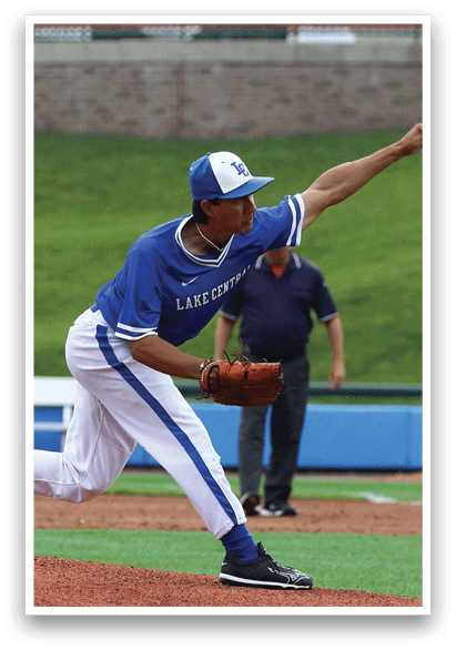 A baseball player in a blue and white uniform is throwing a ball. Description generated by AI
