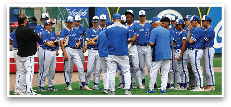 A group of baseball players wearing blue and white uniforms. Description generated by AI