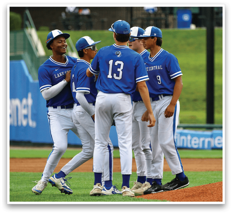 A group of baseball players wearing blue uniforms. Description generated by AI
