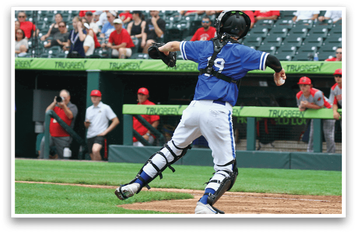 A baseball player wearing a blue shirt and white pants is swinging a bat. Description generated by AI