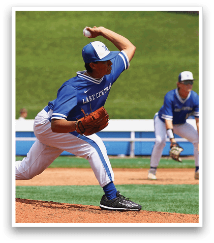 A baseball player in a blue uniform is pitching a ball. Description generated by AI