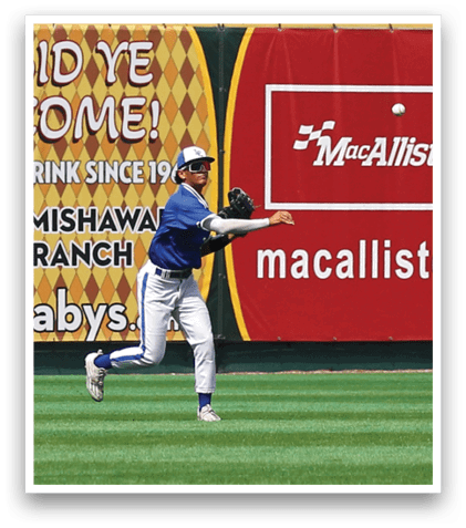 A baseball player wearing a blue shirt and white pants running on a field. Description generated by AI