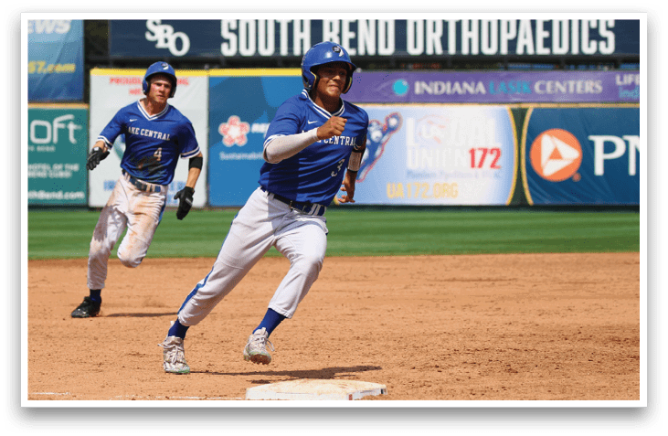 A baseball player in a blue uniform is running towards a base. Description generated by AI