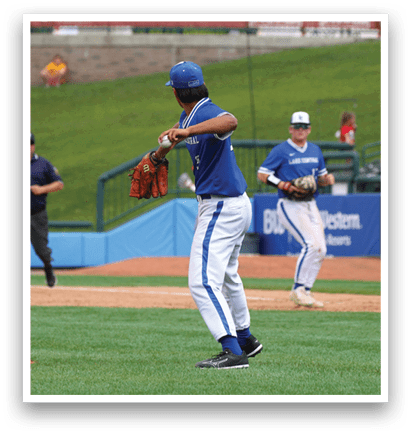 A baseball player in a blue and white uniform is throwing a ball. Description generated by AI